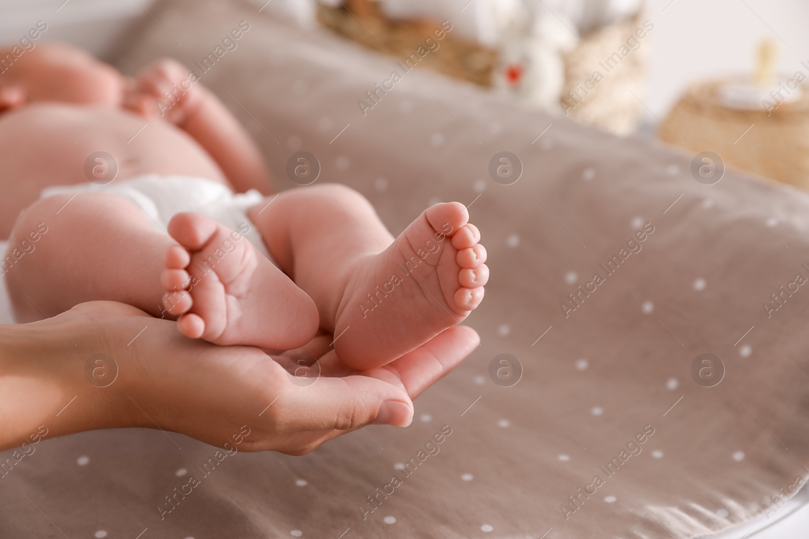 Photo of Mother and her little baby on bed, closeup