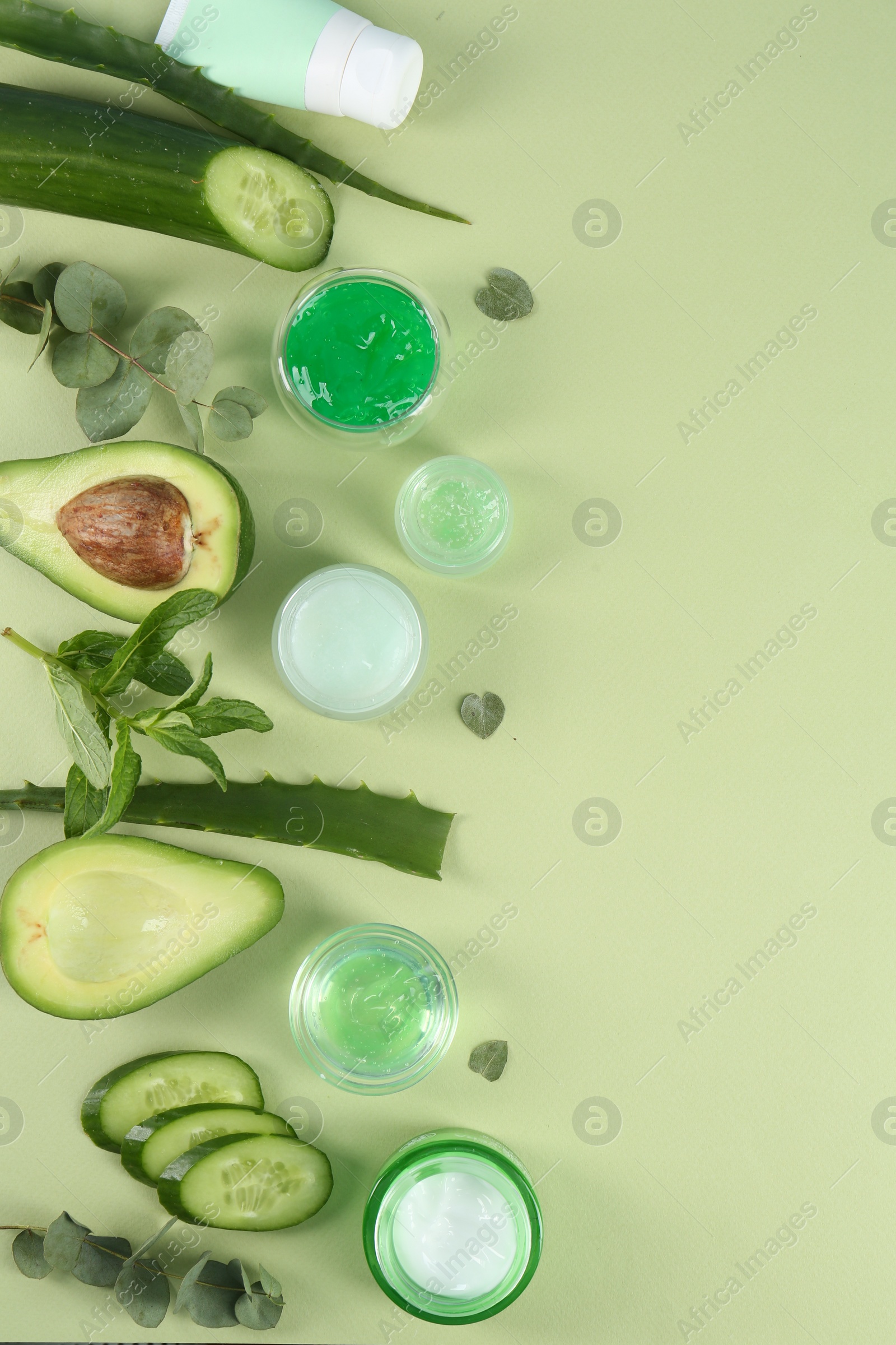 Photo of Flat lay composition with homemade cosmetic products and fresh ingredients on light green background, space for text. DIY beauty recipe