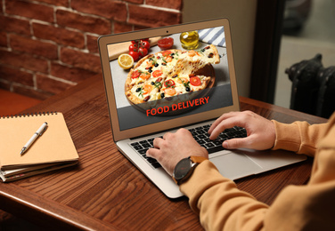 Image of Man using laptop for online food order during quarantine, closeup. Delivery service