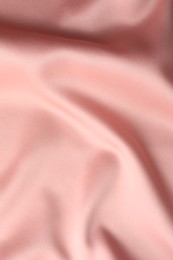 Photo of Crumpled pink silk fabric as background, top view
