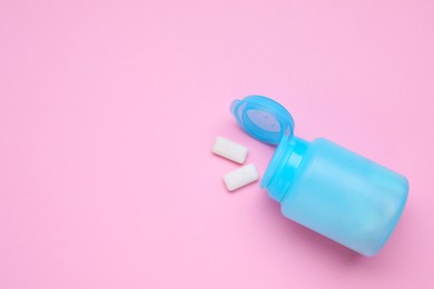 Photo of Jar with chewing gums on pink background, top view. Space for text