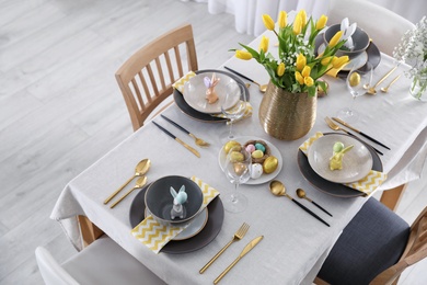 Beautiful Easter table setting with festive decor indoors, above view