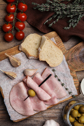 Photo of Tasty ham served on wooden table, flat lay