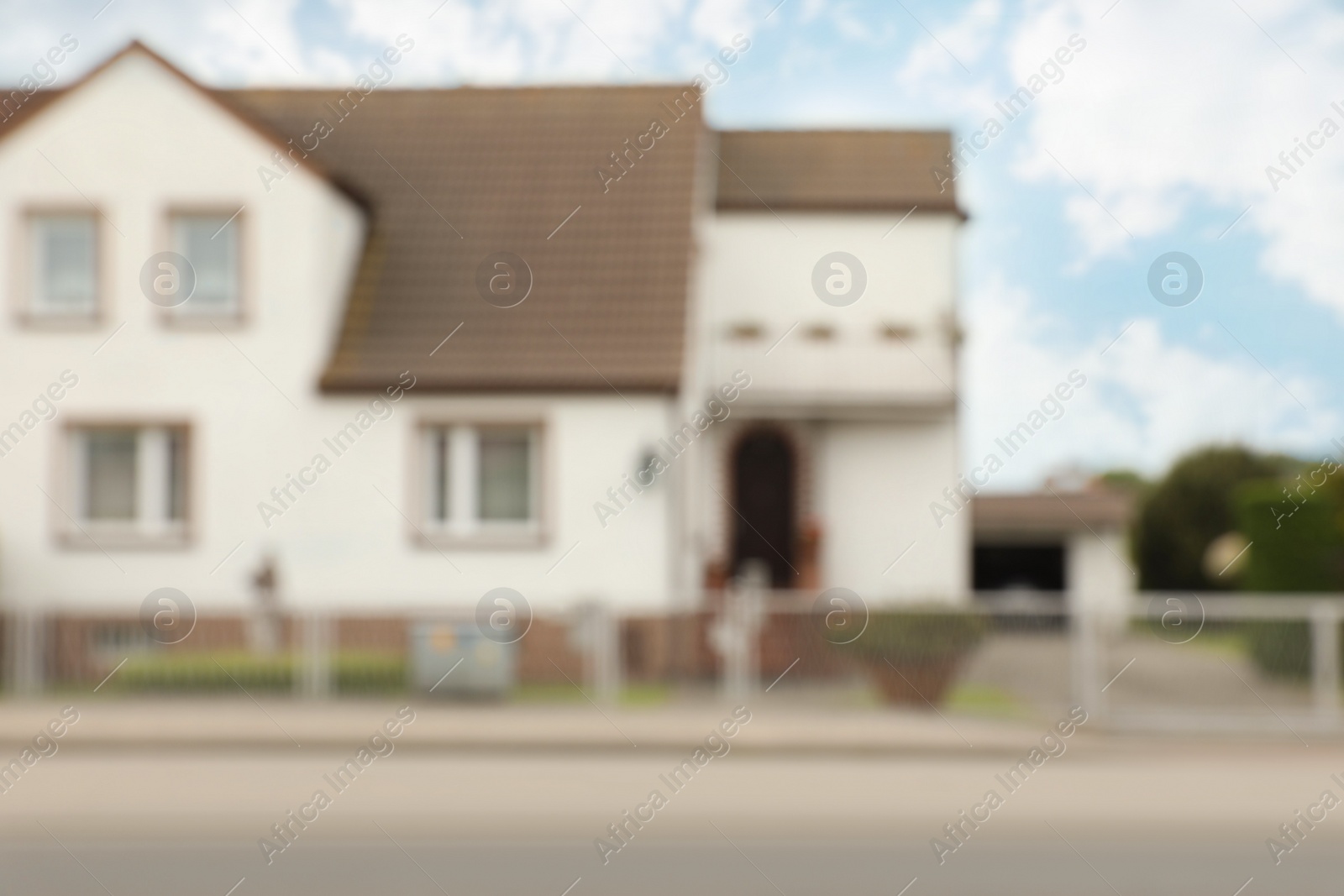 Photo of Blurred view of suburban street with beautiful house