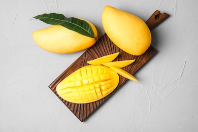 Flat lay composition with mango on grey background