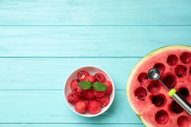 Flat lay composition with watermelon balls on light blue wooden background, space for text