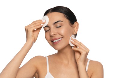 Photo of Young woman using cotton pads with micellar water on white background
