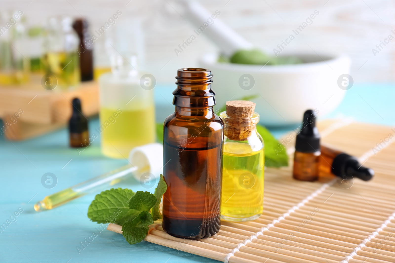Photo of Bottles with essential oils on bamboo mat