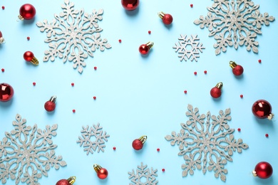 Flat lay composition with Christmas decorations on light blue background