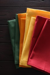 Photo of Different colorful napkins on wooden table, top view