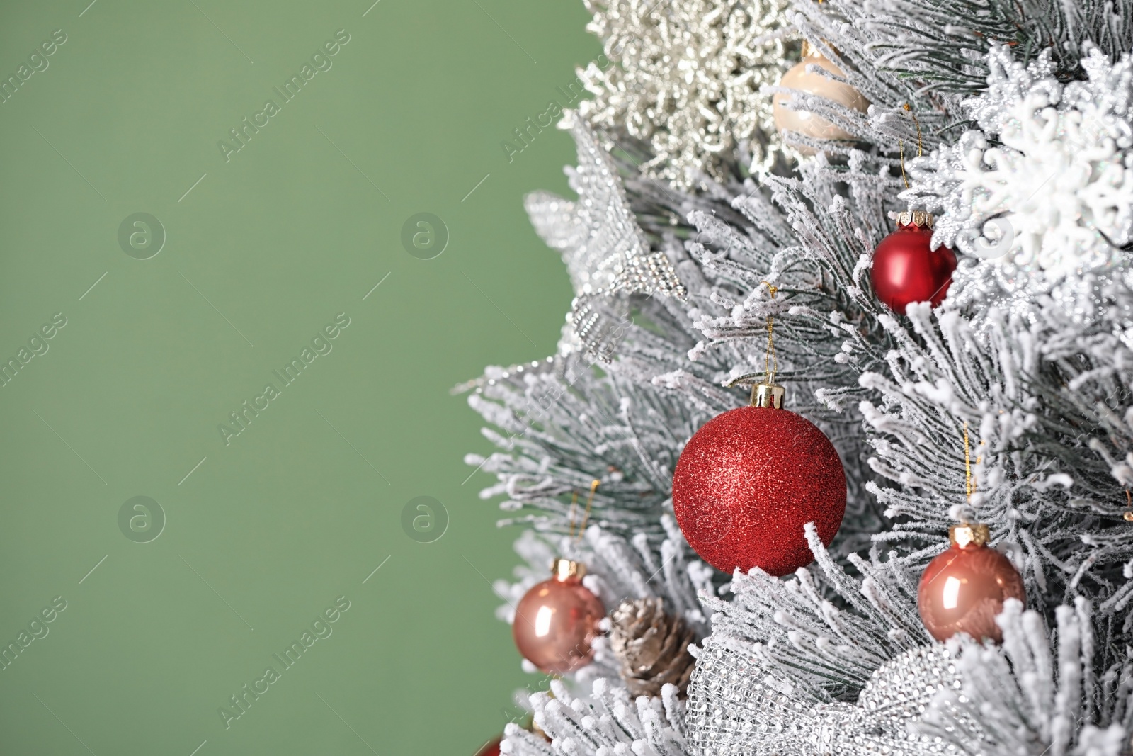 Photo of Beautiful Christmas tree with festive decor on green background. Space for text