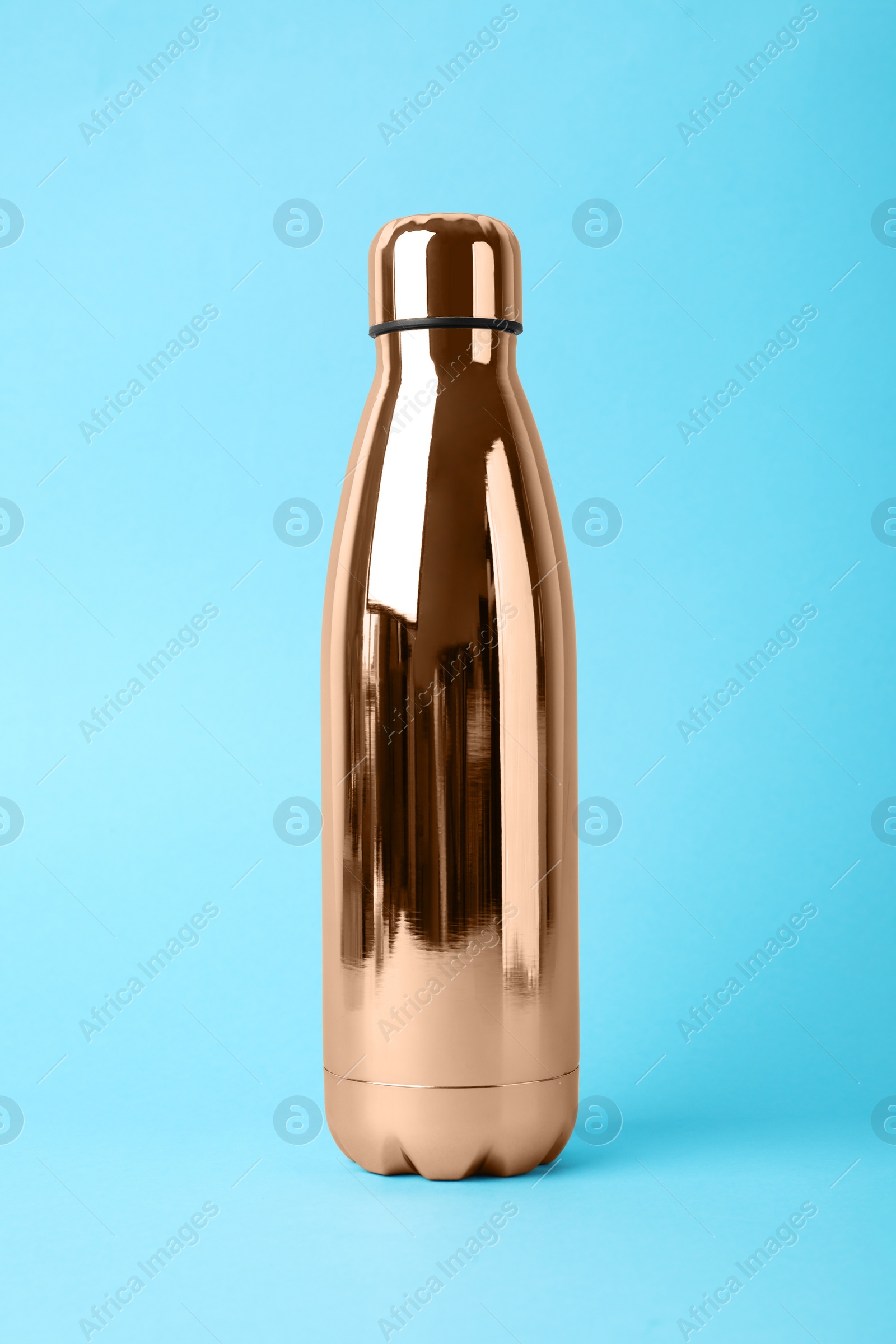 Photo of Metal bottle on light blue background. Conscious consumption
