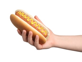 Woman holding delicious hot dog with mustard on white background, closeup