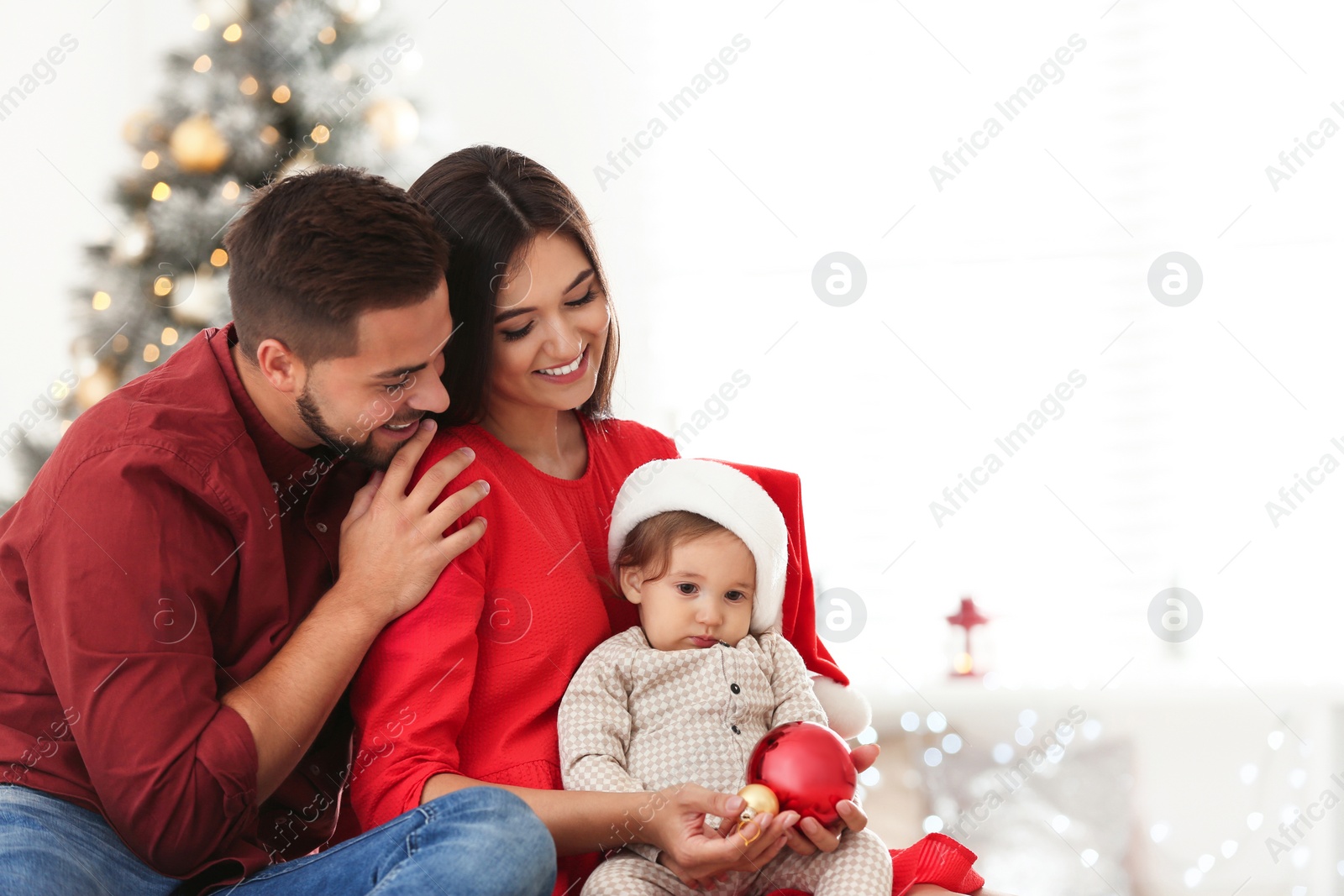 Photo of Happy family with cute baby at home. Christmas celebration