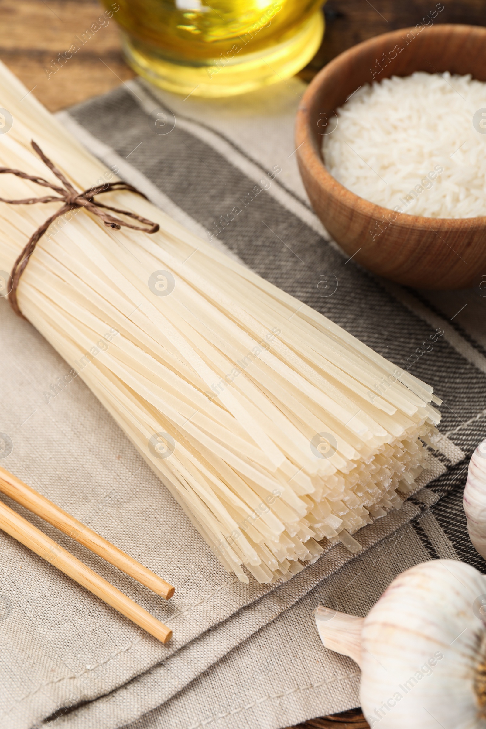 Photo of Uncooked rice noodles on grey napkin, closeup
