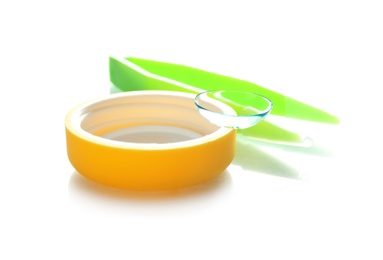 Photo of Plastic cap with contact lens and tweezers on white background