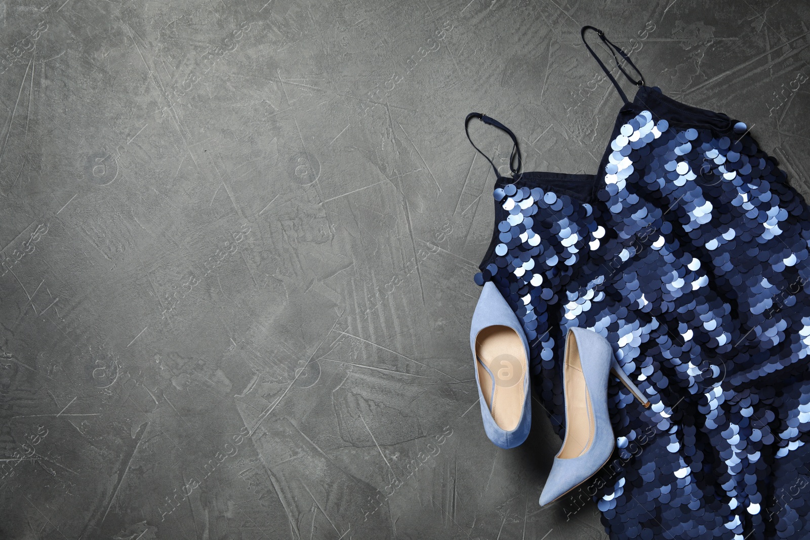 Photo of Stylish blue palette dress and shoes on grey stone background, flat lay