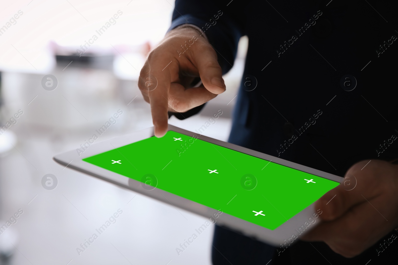 Image of Businessman using digital tablet indoors, closeup. Device display with chroma key