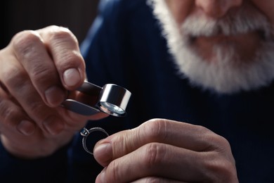 Professional jeweler working with ring, closeup view