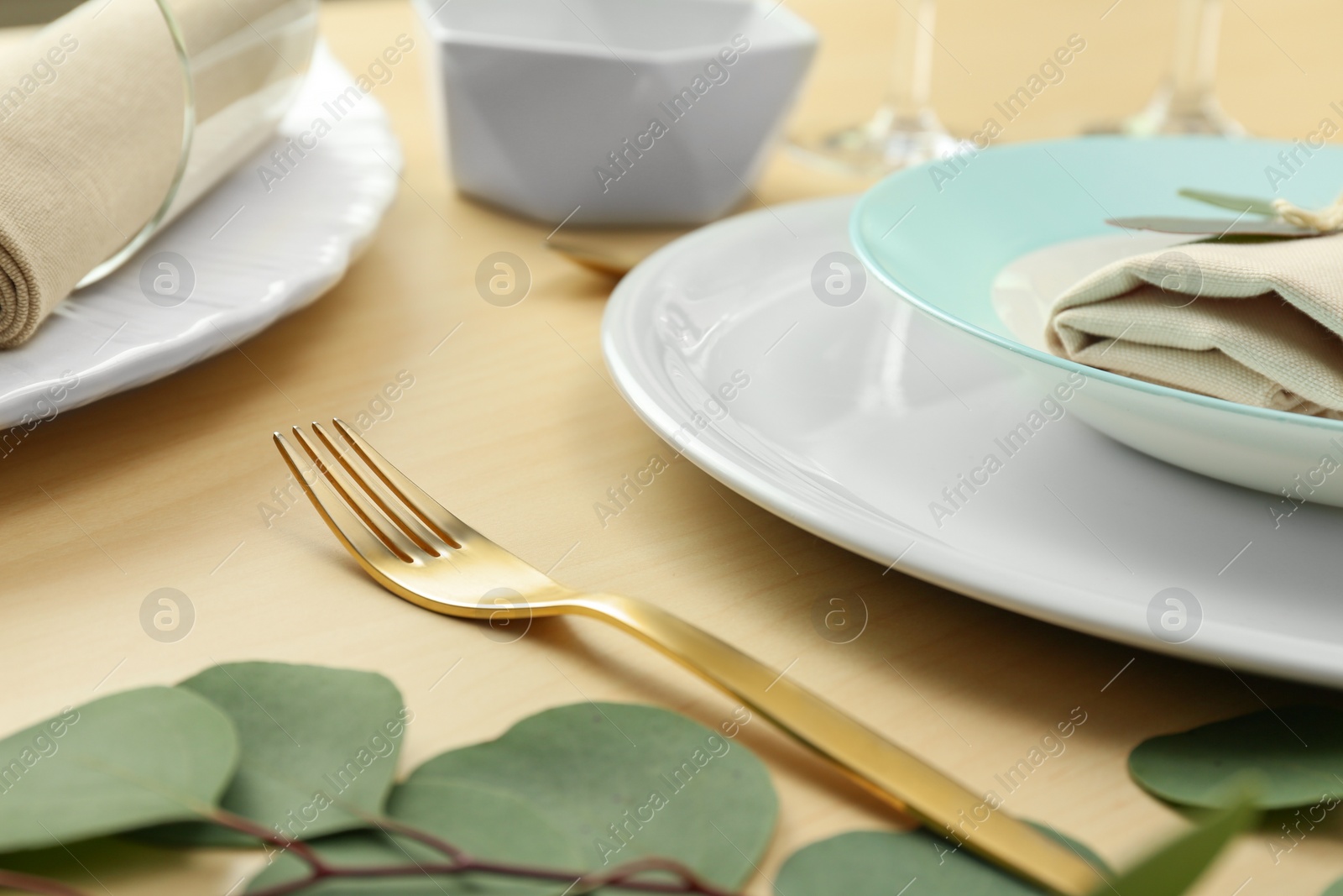 Photo of Elegant table setting with with golden cutlery, closeup