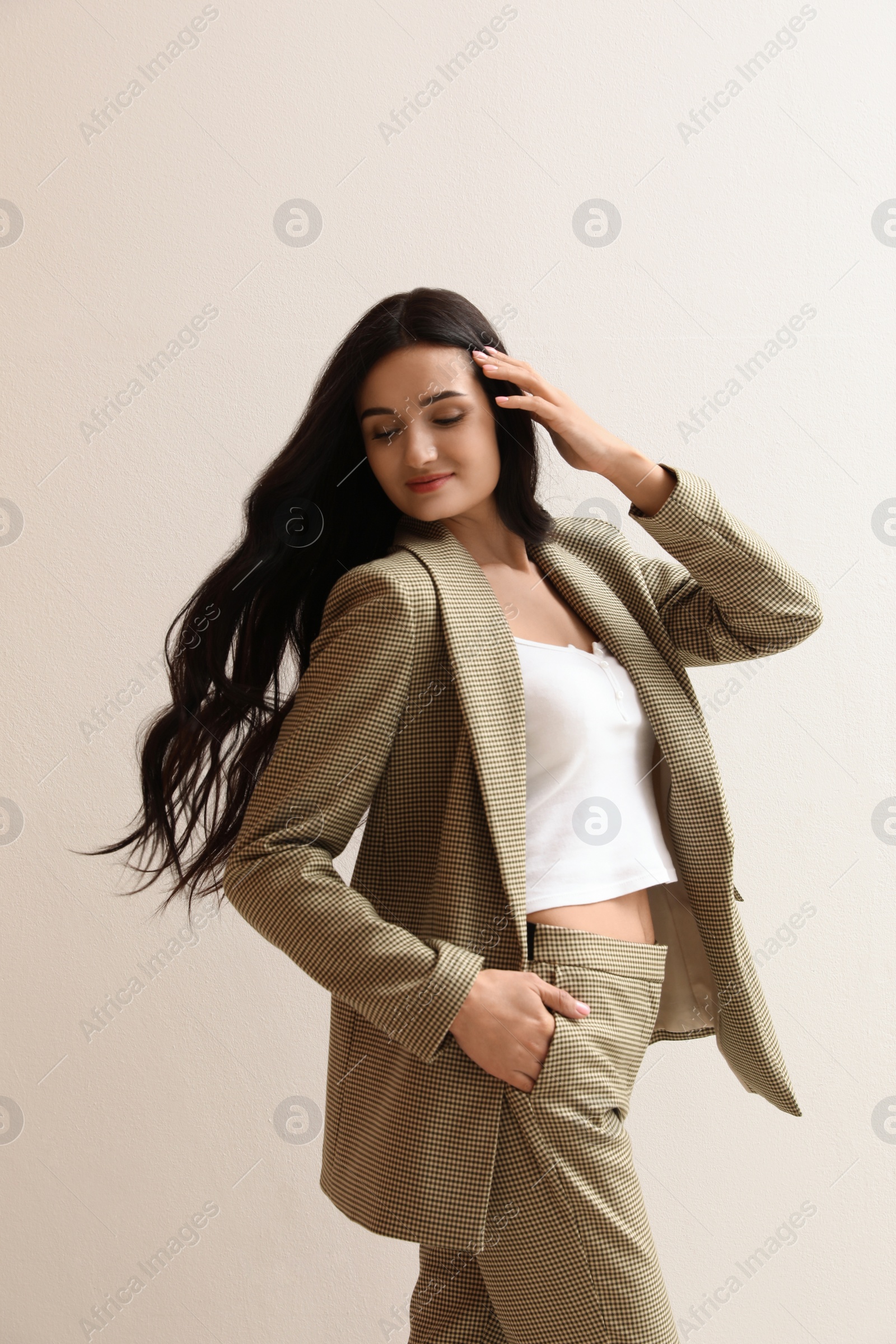 Photo of Beautiful woman in formal suit on light background. Business attire