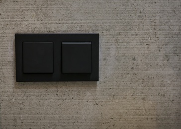 Photo of Light switches on wall. Space for text