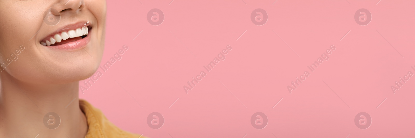 Image of Woman with clean teeth smiling on pink background, closeup. Banner design with space for text