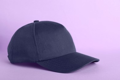Photo of Baseball cap on violet background. Mock up for design