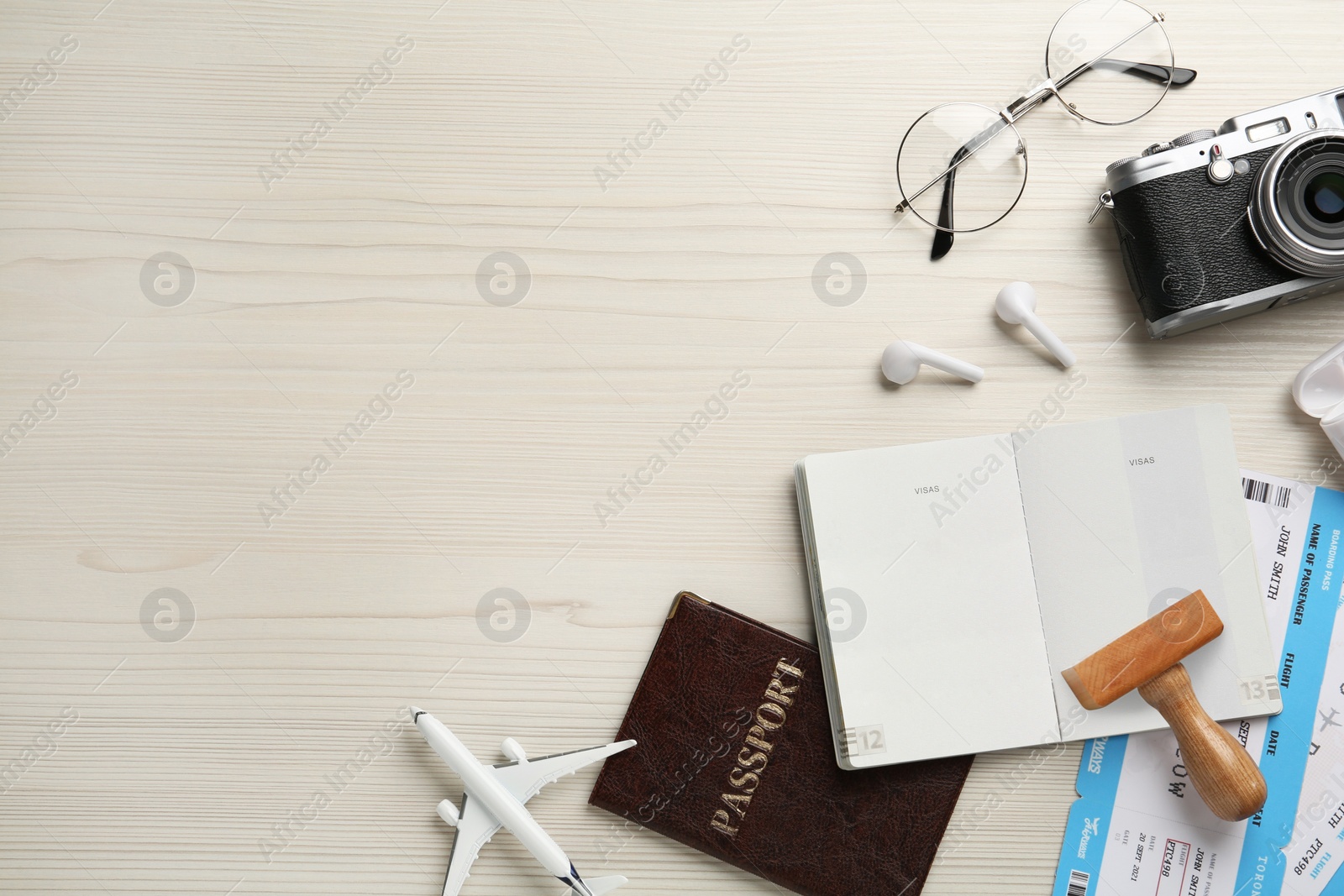 Photo of Flat lay composition with passports, stamp and flight tickets on white wooden table, space for text