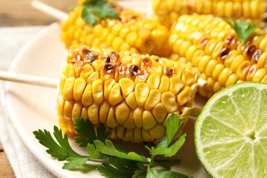 Photo of Tasty grilled corn and lime, closeup view