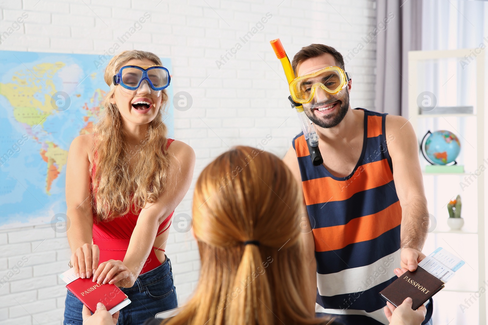 Photo of Beautiful young couple visiting travel agency office