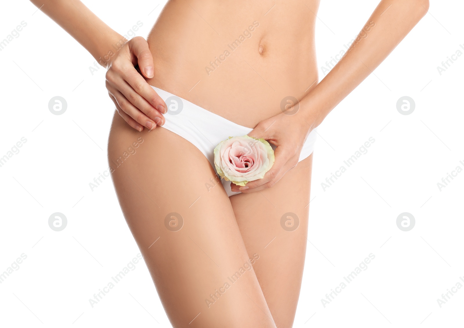 Photo of Woman with flower showing smooth skin after bikini epilation on white background, closeup. Body care concept