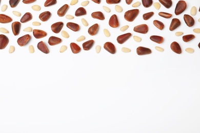 Photo of Composition with pine nuts and space for text on white background, top view