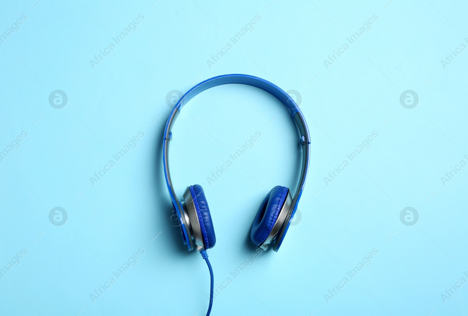 Photo of Stylish headphones on color background, top view