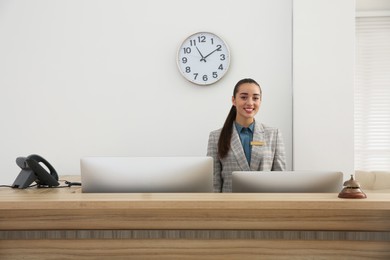 Photo of Portrait of beautiful receptionist at counter in hotel