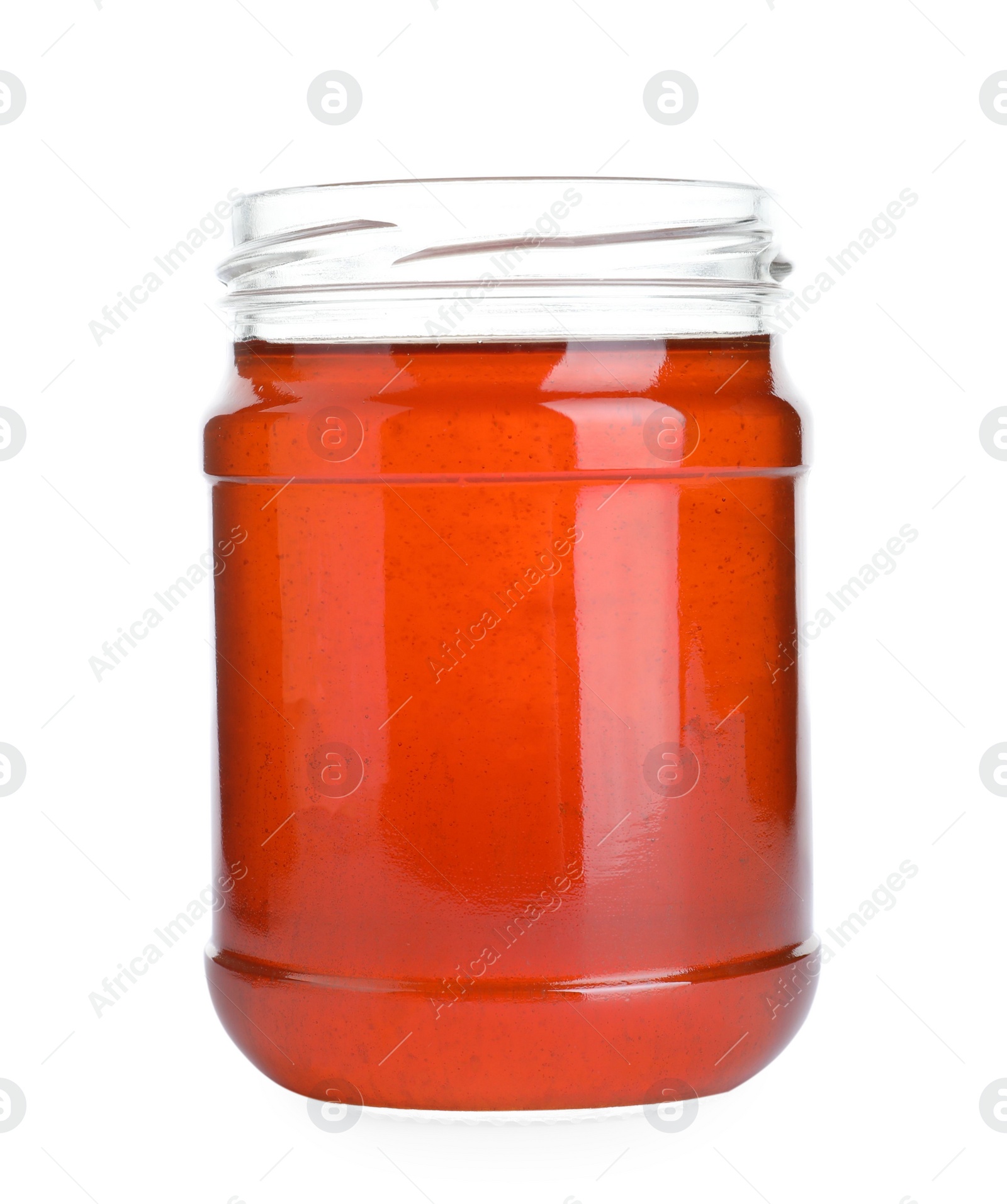 Photo of Open glass jar of wildflower honey isolated on white