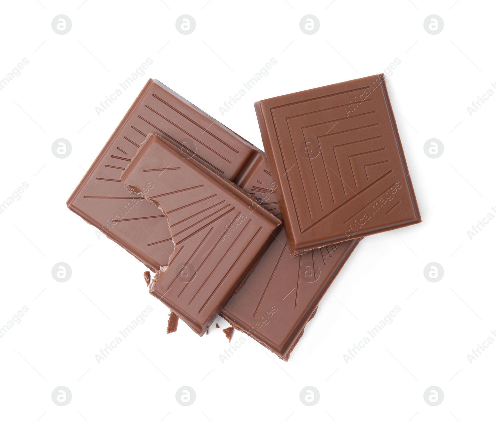 Photo of Broken milk chocolate bar on white background, top view