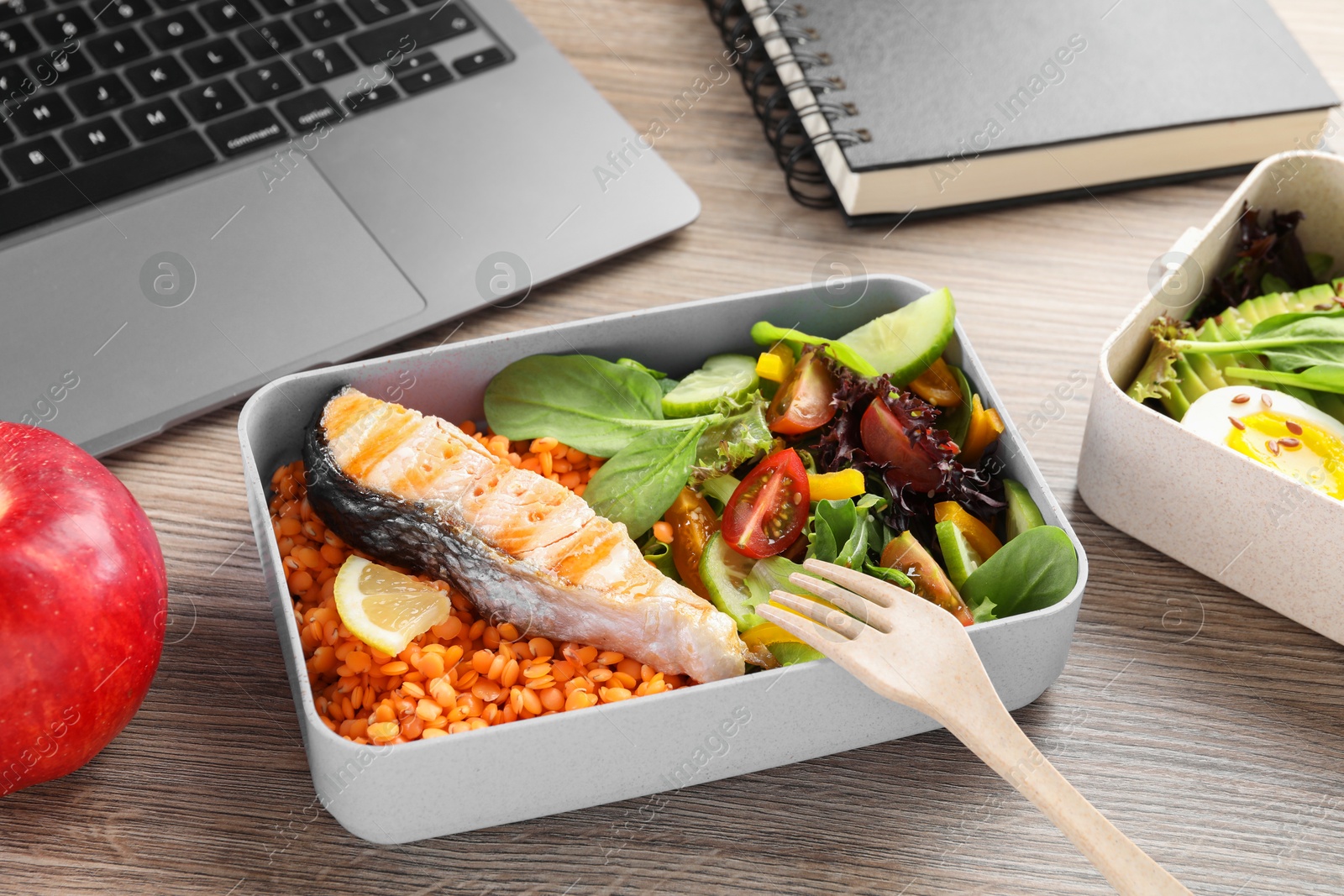 Photo of Healthy products high in vegetable fats near laptop on wooden table, closeup