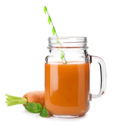 Photo of Carrot and mason jar with fresh juice on white background