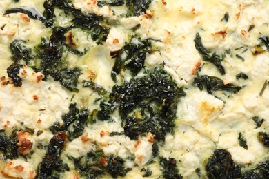 Photo of Delicious homemade spinach quiche as background, closeup