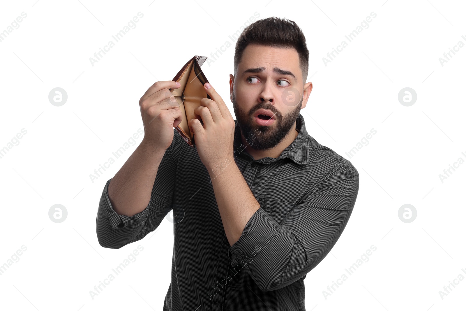 Photo of Confused man showing empty wallet on white background