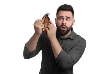 Confused man showing empty wallet on white background