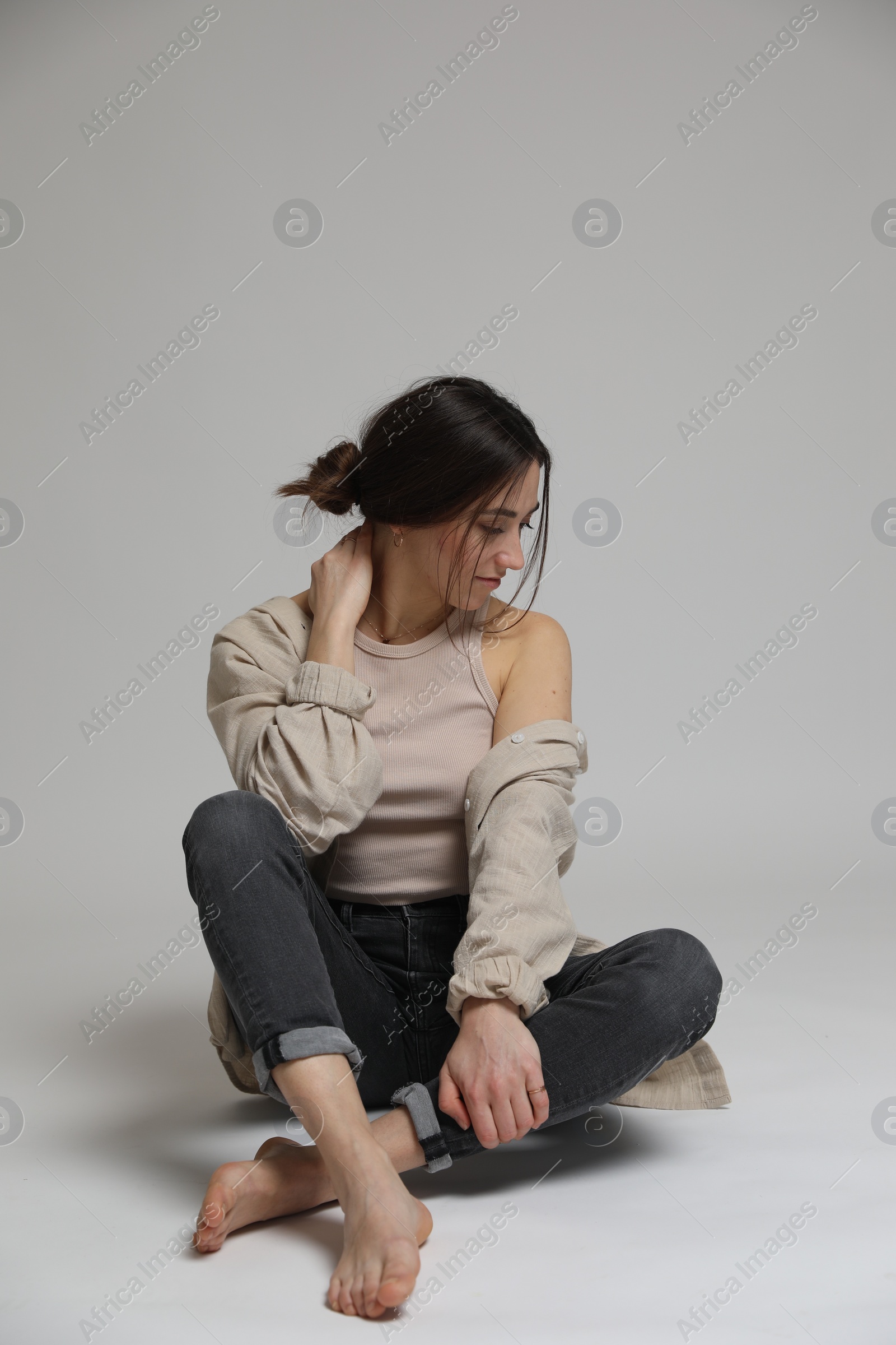 Photo of Portrait of beautiful woman on light grey background