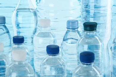 Photo of Set of different plastic bottles with pure water, closeup