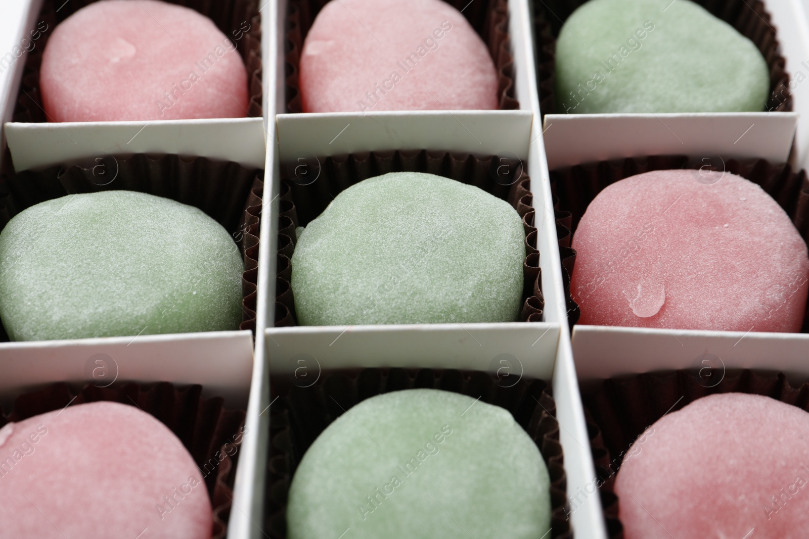 Photo of Box with different delicious mochi as background, closeup. Traditional Japanese dessert