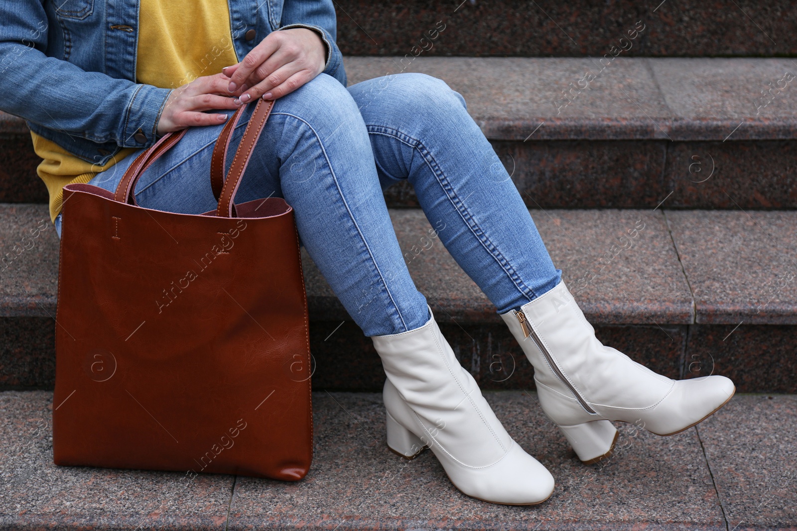 Photo of Woman in stylish leather shoes with bag on stairs outdoors, closeup