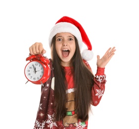 Photo of Girl in Santa hat with alarm clock on white background. New Year countdown
