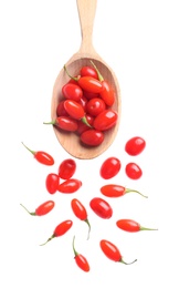 Fresh ripe goji berries and spoon on white background, top view