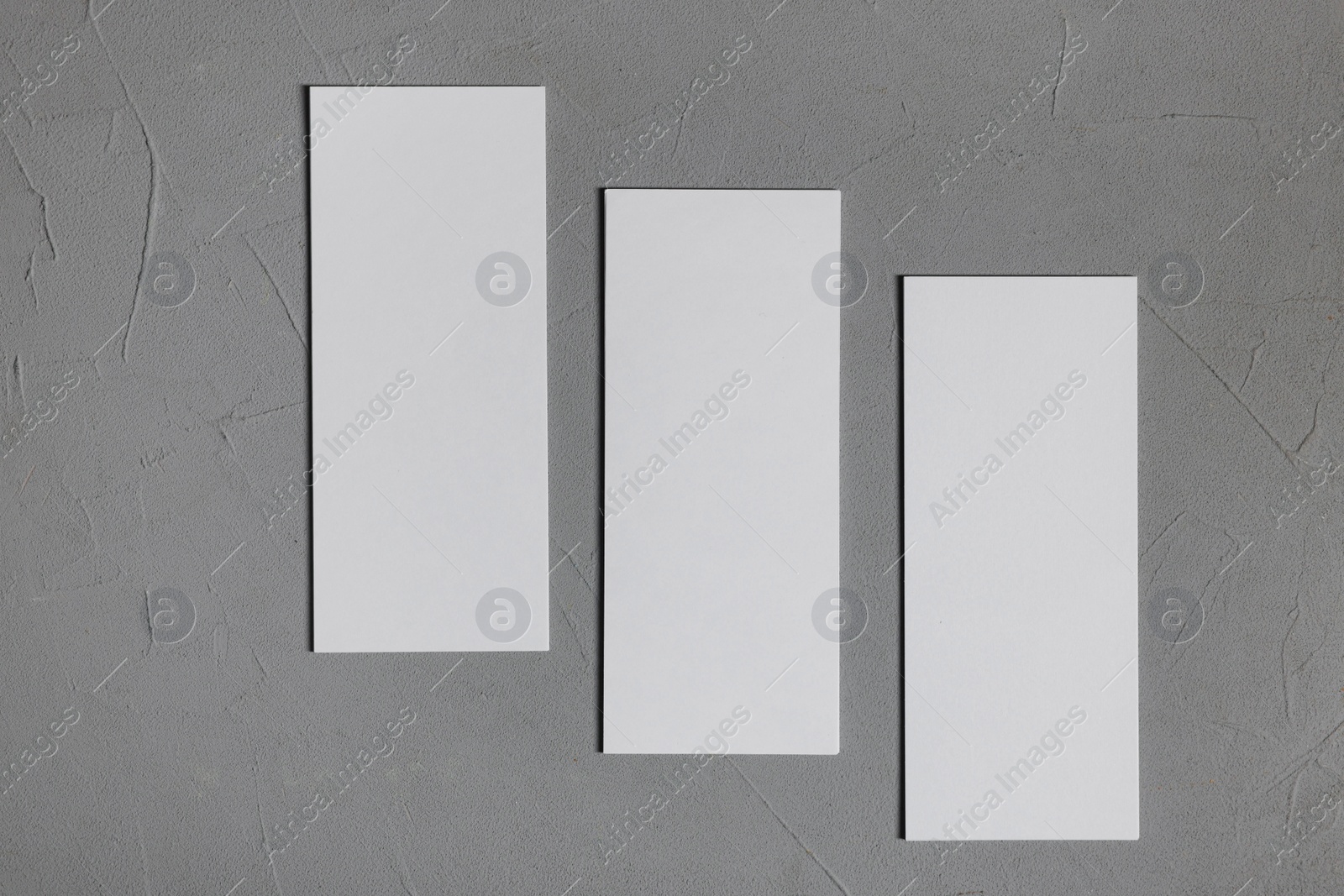 Photo of Blank business cards on grey textured background, top view. Mockup for design