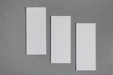 Blank business cards on grey textured background, top view. Mockup for design